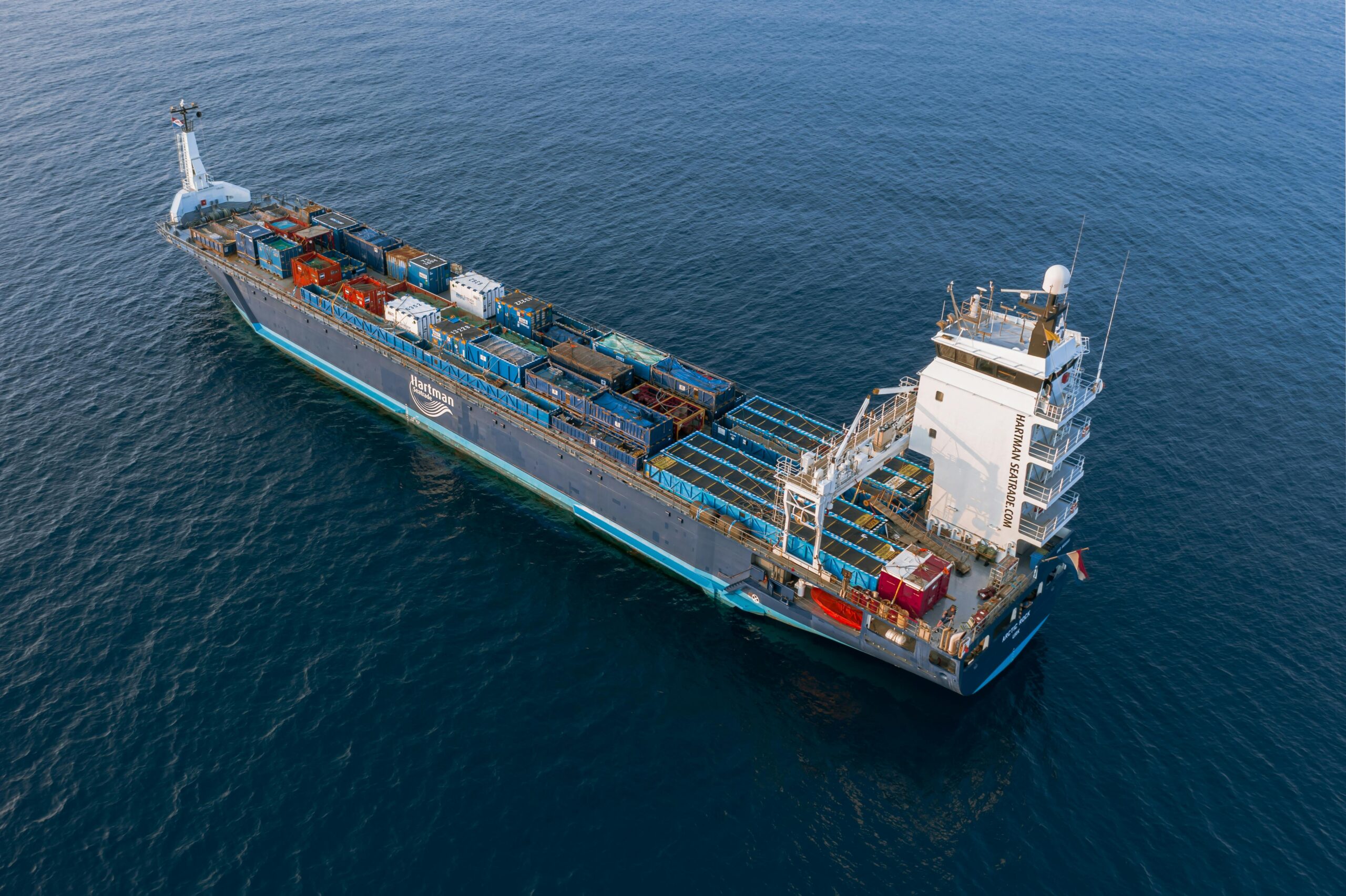A container feeder vessel at sea with deck equipment; typical OPS berth loads range 1–5 MW